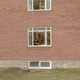 A refugee looks from a window in the Sweden’s largest temporary camp for refugges at the former psychiatric hospital Restad Gard on February 12, 2016 in Vanersborg, Sweden. Image via Getty.